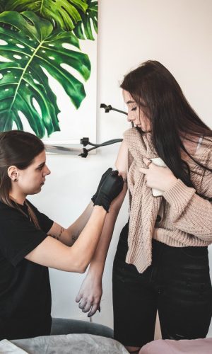 Klientka dowiaduje się od tatuatorki jak dbać o tatuaż